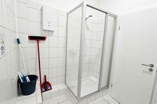a shower with a glass door in a bathroom at Apartments in Altena in Altena