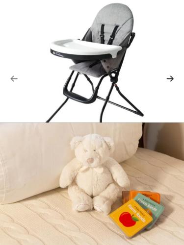 a stuffed teddy bear sitting in a high chair at Varkiza Sea View Apartment - Free Parking in Vari