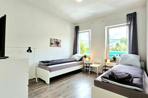 a bedroom with a bed and a desk and a window at Apartments in Altena in Altena