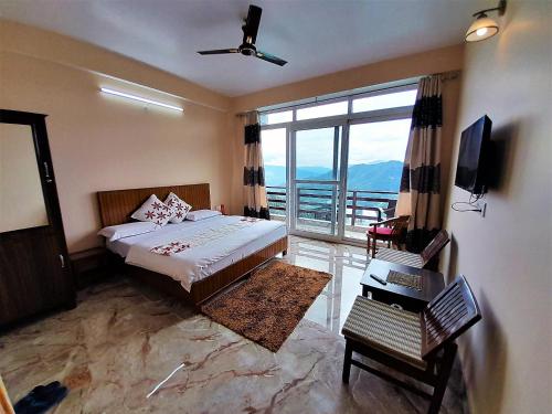 a bedroom with a bed and a large window at Mountain and peace in Shimla