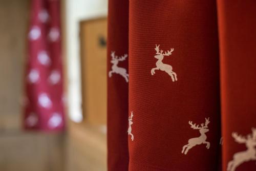 a red curtain with drawings of deer on it at Hotel Panorama in Fleres