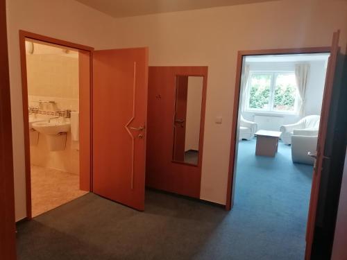 a room with a bathroom with a toilet and a window at Hotel Kaskáda in Bojnice