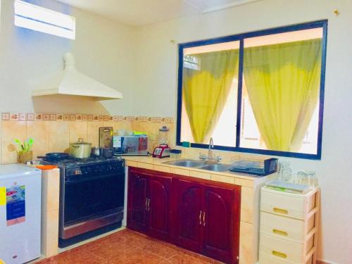 a kitchen with a sink and a stove and a window at View n Wide/Green Place in Cuenca