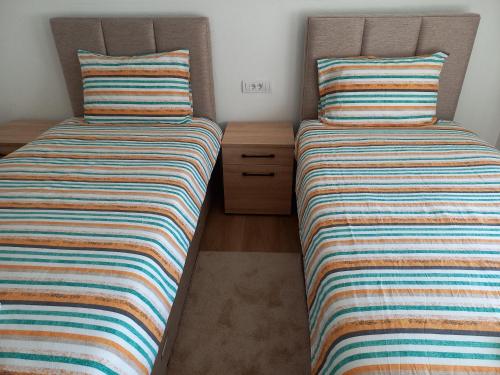 two beds sitting next to each other in a room at Golden House in Kolašin