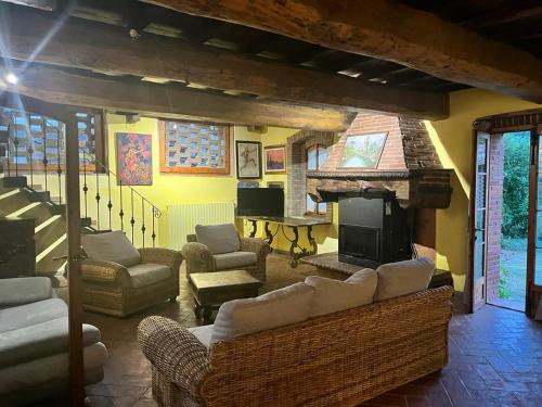 a living room with couches and a fireplace at Molino in chianti in Mercatale Val Di Pesa