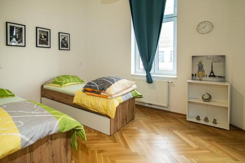 um quarto com 2 camas e uma janela em Raimond Apartment em Viena