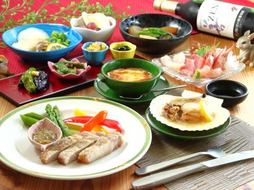 a table with plates of food and bowls of food at Villa Monrepos in Myoko