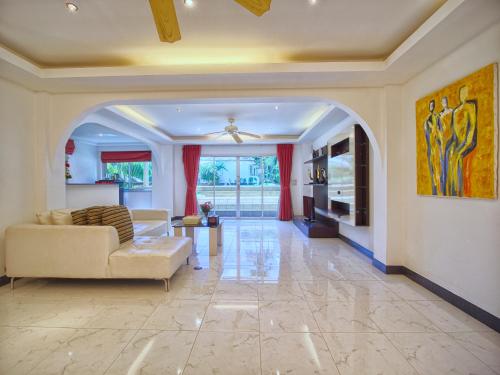 a living room with a couch and a table at Serenity Lakeside Resort in Kathu