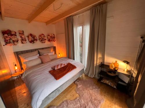 a bedroom with a large bed and a window at Bloom& Breakfast in Kleve