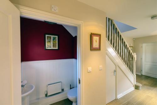 a bathroom with a toilet and a sink at Camber Cottage in Camber