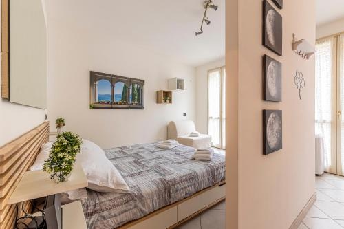 a white bedroom with a bed and a desk at LAGO DI COMO - In Centro a 1 min da Lago e Stazione - Wifi in Lecco