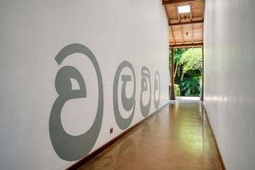 a hallway with a large sign on a wall at Wallawwa in Katunayake