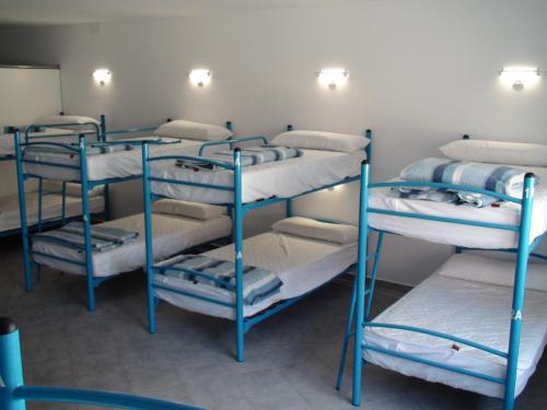 a group of bunk beds in a room at Albergue @ Muxia in Muxia