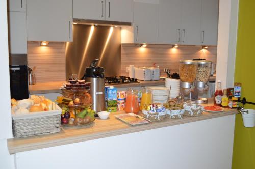 a counter with food and drinks on it in a kitchen at Hotel Ambrosia in Ieper