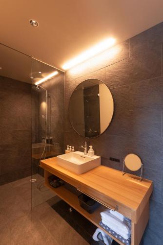 a bathroom with a sink and a mirror at NODE SAIGAWA in Kanazawa