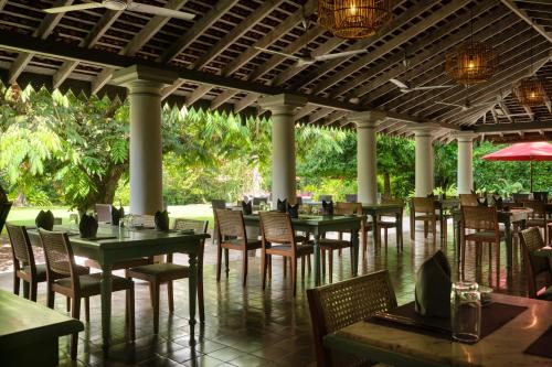 a row of tables and chairs in a restaurant at Wallawwa in Katunayake