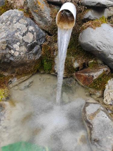 a stream of water coming out of a fountain at Rakaposhi Amin Hotel & Restaurant Pissan Hunza Nagar Gilgit Baltistan in Gilgit