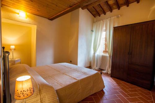 a bedroom with a large bed and a window at Borgo alle Mura in Casale Marittimo