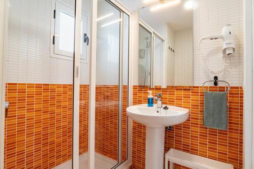 a bathroom with a sink and a shower at Las Casitas de Corralejo in Corralejo