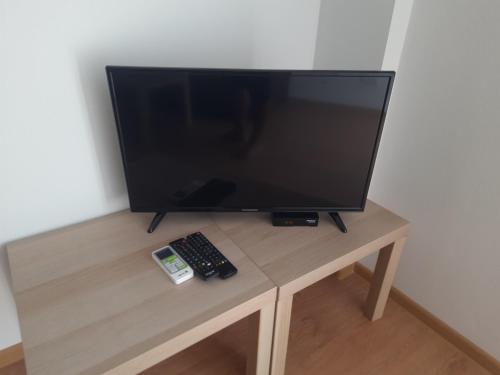 a flat screen tv sitting on top of a wooden table at Nino Lux Apartments Ulcinj in Ulcinj