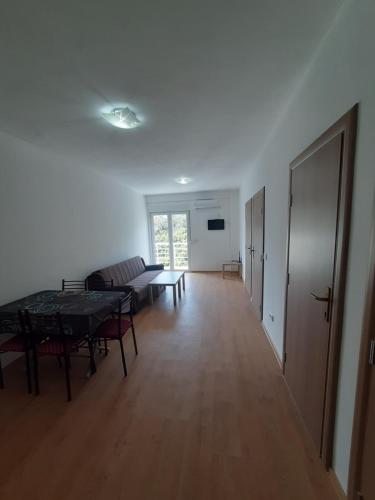 a living room with a table and a couch at Nino Lux Apartments Ulcinj in Ulcinj