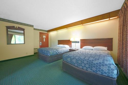 a hotel room with two beds and a window at Broadway Inn Portland Downtown in Portland