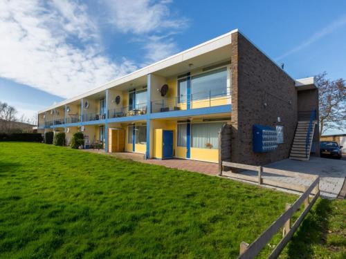 a building with a green field in front of it at Attractive apartment near Vlissingen beach in Vlissingen