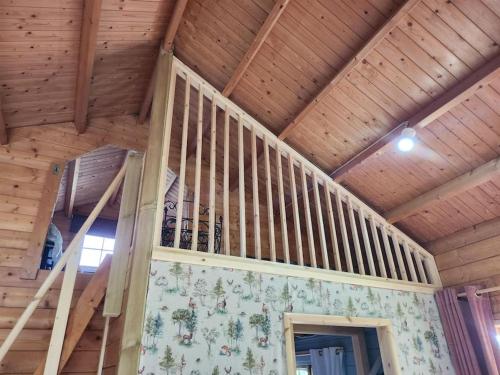 a staircase in a house with wooden ceilings at The Meadow in Lapworth