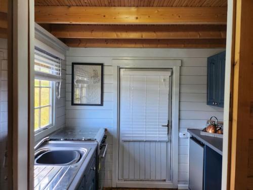 a small kitchen with a sink and a stove at The Meadow in Lapworth