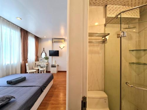 um quarto com uma cama e uma cabina de duche em vidro em Libré Homestay Đào Tấn em Hanói