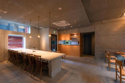 een keuken en eetkamer met een grote tafel en stoelen bij NODE SAIGAWA in Kanazawa