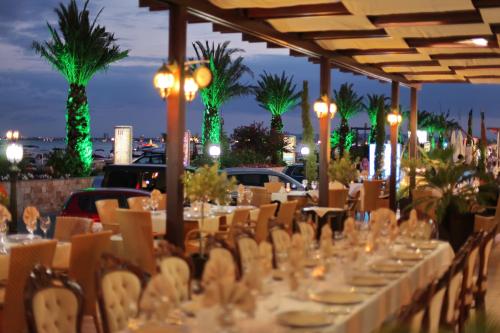 a table set up for a party with tables and chairs at Hotel Palace Marina Dinevi in Sveti Vlas