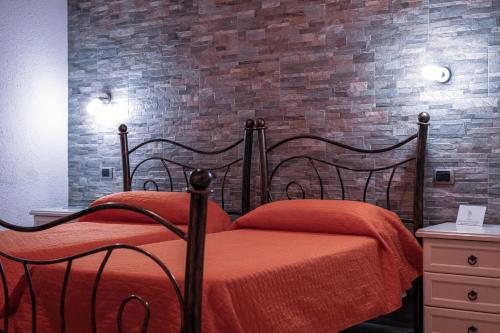 a bedroom with a bed and a brick wall at Mare Sole in San Teodoro