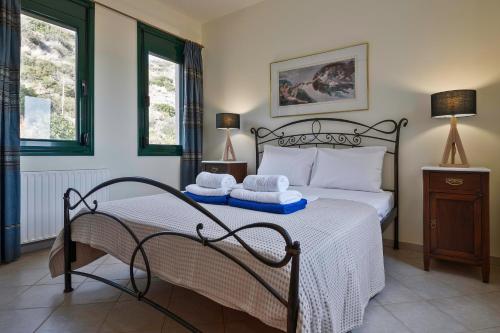 a bedroom with a bed with towels on it at Marisia Apartments und Villa in Keratokampos