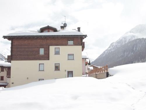 a building with snow on the ground in front of it at Modern Holiday Home in Livigno Italy near Ski Area in Livigno