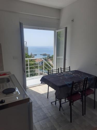 a kitchen with a table and a view of the ocean at Nino Lux Apartments Ulcinj in Ulcinj