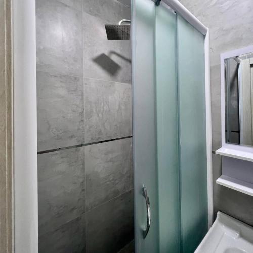 a shower with a glass door in a bathroom at Afsona Hotel in Bukhara