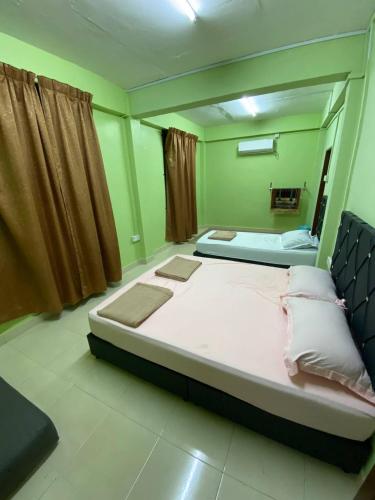 Ένα ή περισσότερα κρεβάτια σε δωμάτιο στο Homestay IJAA