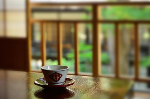 a coffee cup sitting on top of a table at Houshi Onsen Chojukan in Minakami