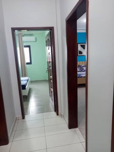 a hallway with two doors and a mirror at Matera YameHome in Yaoundé
