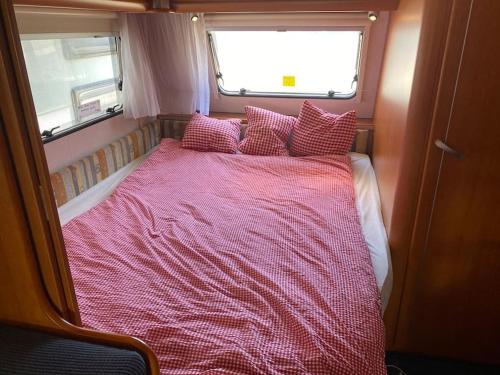 a bed in the middle of a room at ***** Camping Aufenfeld - Sonnenglückhütte in Aschau
