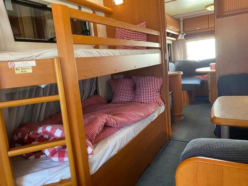 a couple of bunk beds in a train at ***** Camping Aufenfeld - Sonnenglückhütte in Aschau