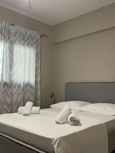 two beds in a bedroom with towels on them at Elaia Apartment in Kavála