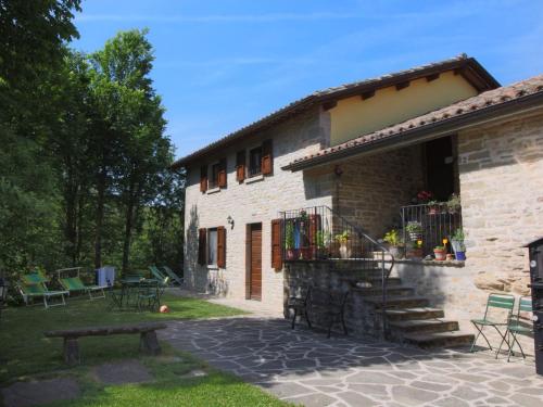 a stone house with a bench in front of it at Country Cottage in Marche with Swimming Pool in Apecchio
