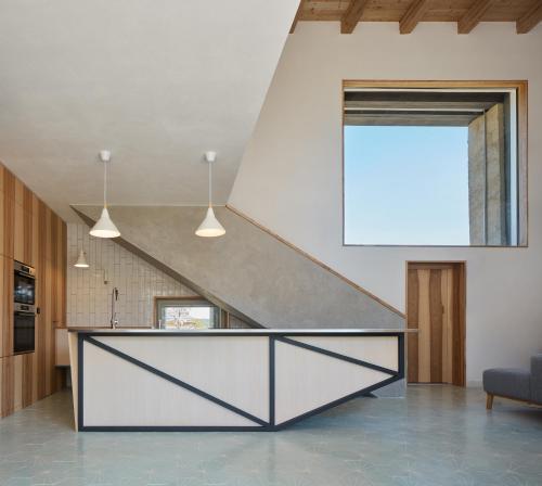 a staircase in a house with a counter in a kitchen at Sýpka Arnoštov 