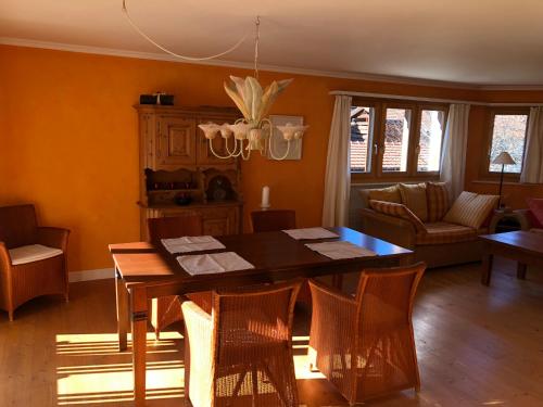 a dining room with a wooden table and chairs at Plattis 4 in Klosters