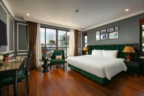 a bedroom with a large bed and a large window at La Selva Premium Hotel in Hanoi