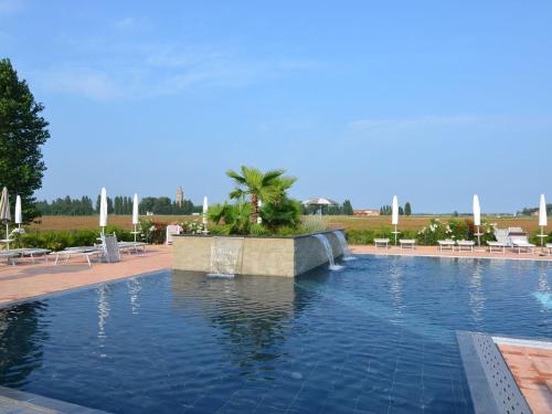 a large swimming pool with a fountain in a resort at Characteristic apartment in Codigoro with pool in Codigoro