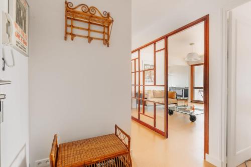 a hallway with a chair and a mirror at Sixties 64 2 bedrooms apartment with a balcony and parking in Biarritz in Biarritz