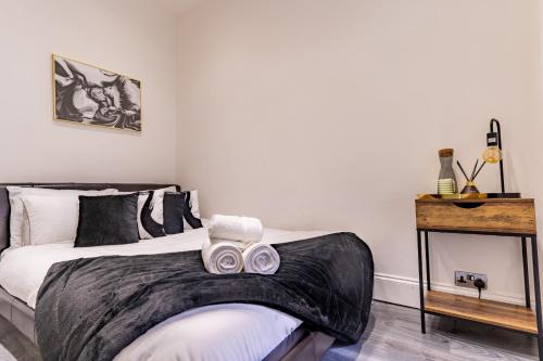 a bedroom with a bed with two masks on it at Prime Location - Cosy Apartment near Emirates Stadium in London